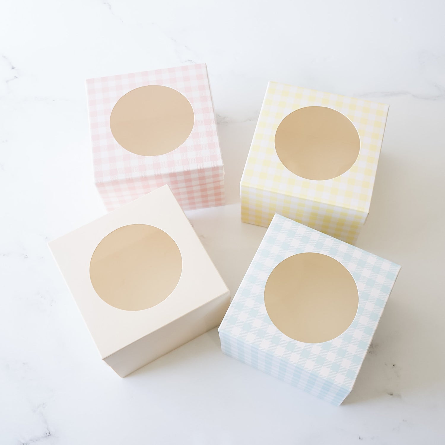 bakery boxes in pink, yellow, ivory and blue