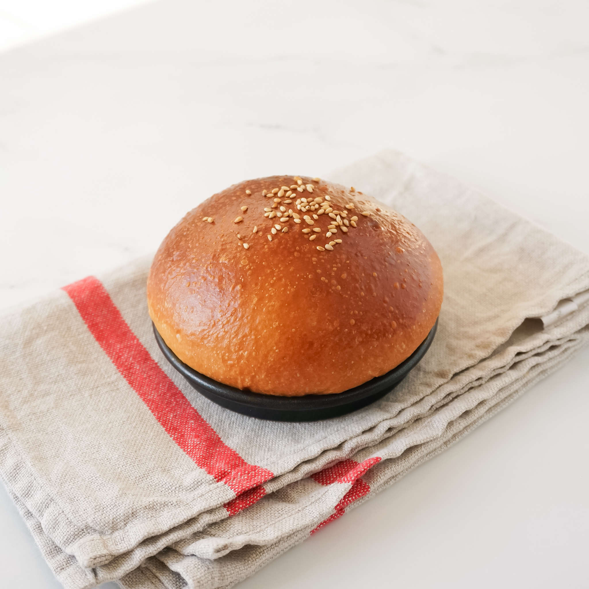 https://www.thekitsuneandco.com/cdn/shop/files/brioche-hamburger-bun-pan.jpg?v=1702517537