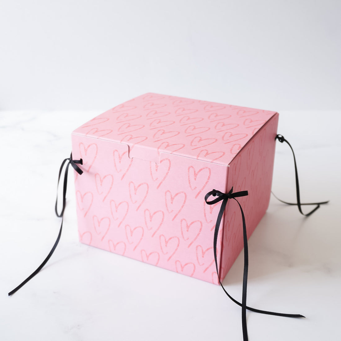 heart printed bakery box with black ribbon