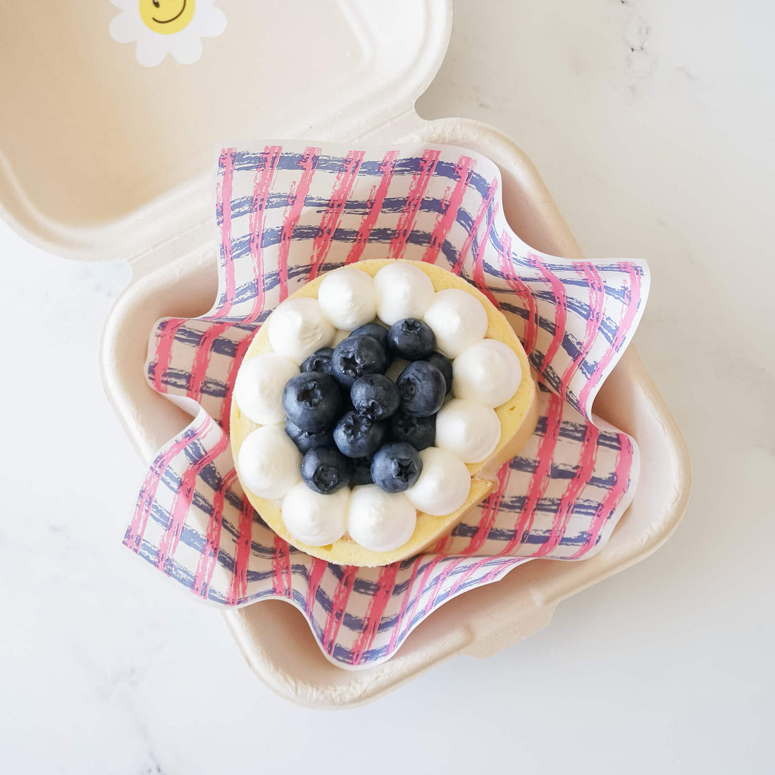 blueberry roll cake, pink and blue check printed deli paper