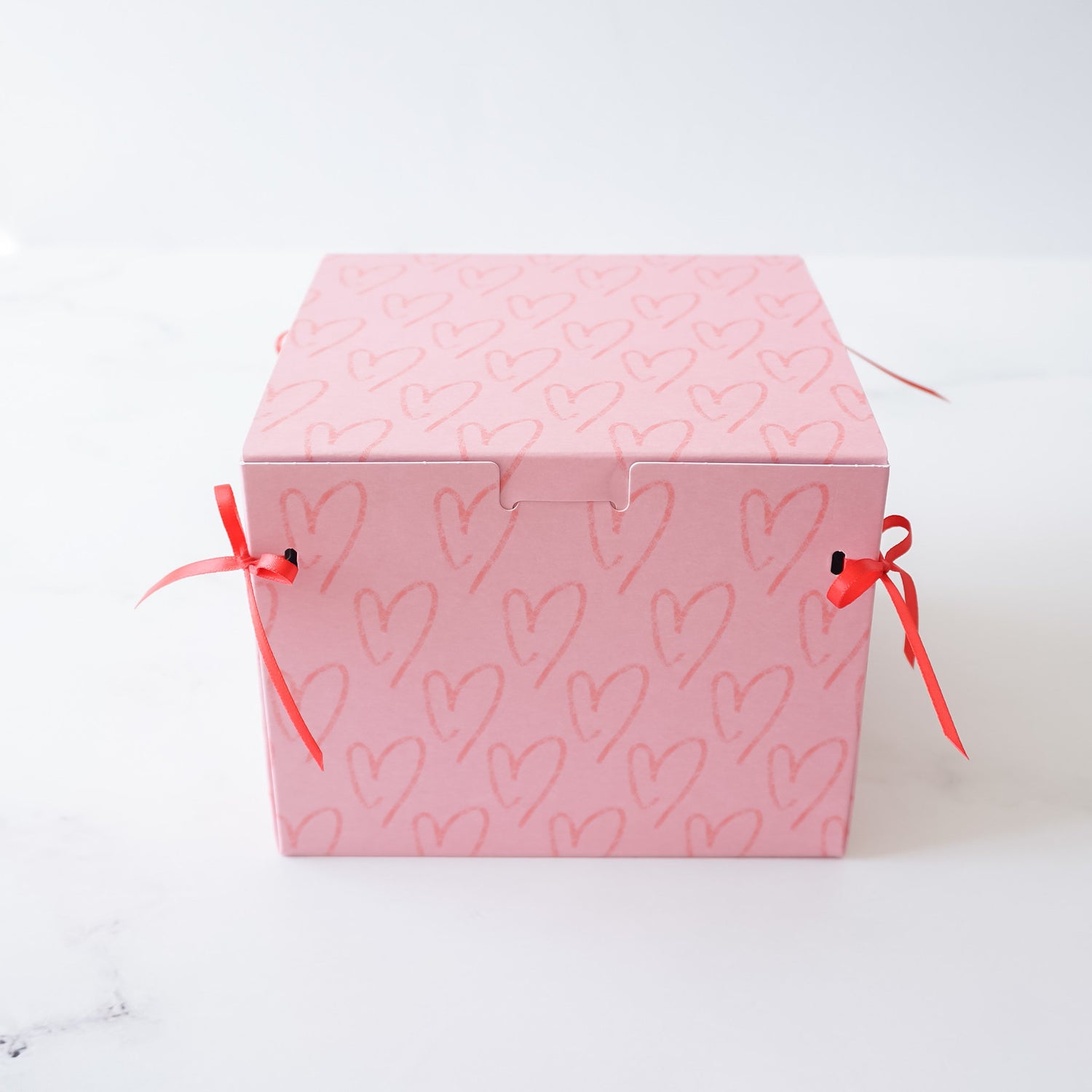 pink cookie box with red ribbon bow