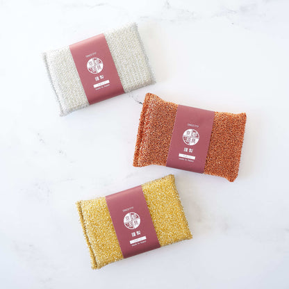 scrub sponges in gold, silver, copper